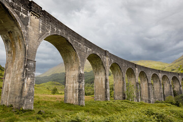 Glenfinnan Viaduct with Jacobite Steam Train Crossing Through the Scottish Highlands