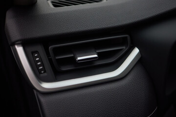 Closeup of car dashboard air vents near gear shift