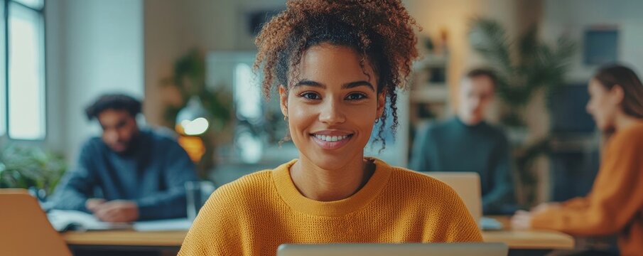 A diverse team of young adults engaging in a meeting with a laptop in a bright, modern office, conveying a dynamic and collaborative work atmosphere, Generative AI - Powered by Adobe
