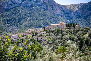 Deia, Mallorca mountain village cityscape with Serra de Tramuntana mountain landscape in the background, buildings on a hill, majorca spain