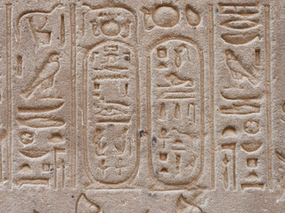 Egyptian hieroglyphic engravings on the stone walls of the temple of the God Horus in Edfu Egypt