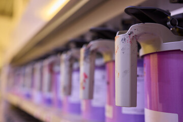 Colorful paint containers are arranged in a studio, showcasing creativity and artistic detail