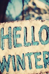 Welcome winter: snow-covered sign celebrating the season