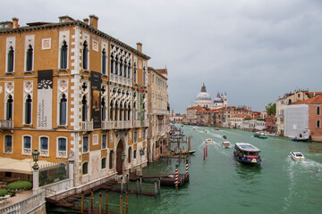 Grand Canal View with Historic Buildings and Basilica in Venice. A stunning view of Venice's Grand Canal with ornate buildings and the iconic Santa Maria della Salute Basilica.