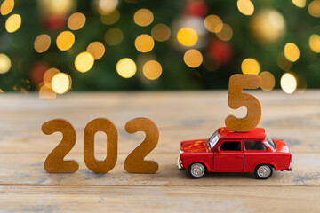 Wooden numbers 2025, toy car carries the number 5