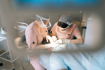 High-angle view of two trichologist specialist collecting hair follicles from back of head of male...
