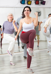 Obraz premium Group of people of different nationalities, engaged in a dance studio, learn sports dance in lesson