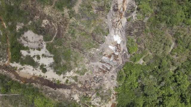 Drone lowers with camera pointing down over Cachoeira do Barata in Tepequem, Roraima, Brazil