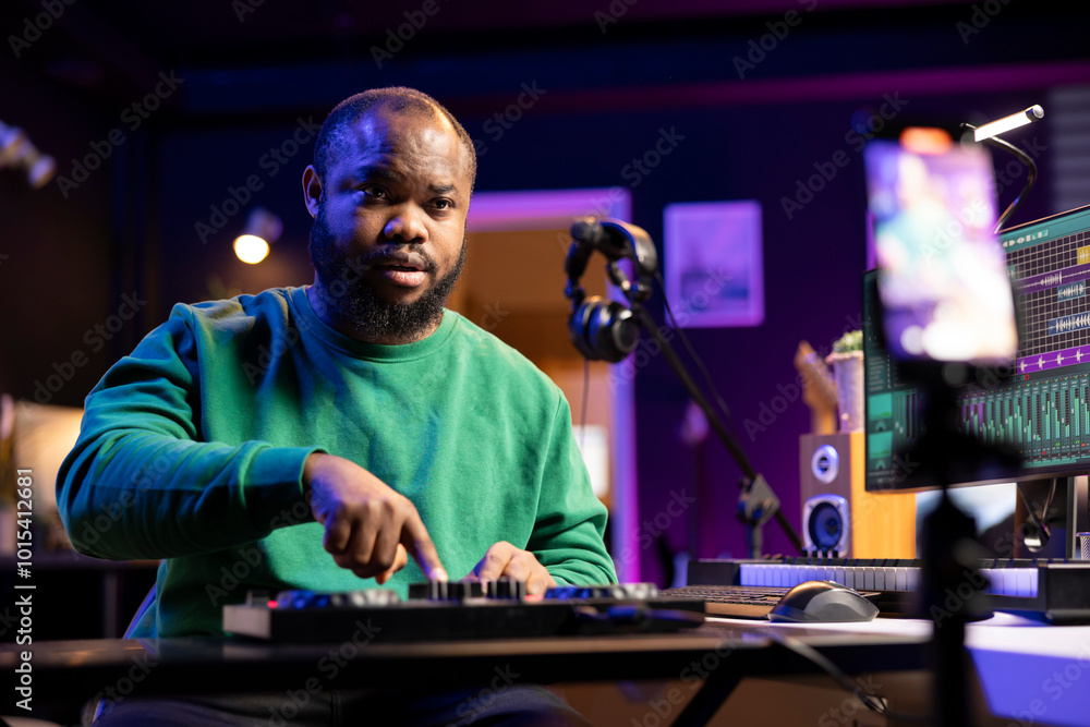 Poster Music producer hosting an online master class lesson to teach controls and buttons on a stereo console, explains editing in post production. Confident musician hosting a mix and master course.