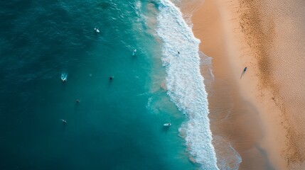 Surfers wait eagerly in the vibrant turquoise waters, with gentle waves lapping the sandy shore, creating a stunning coastal vista under bright sunlight