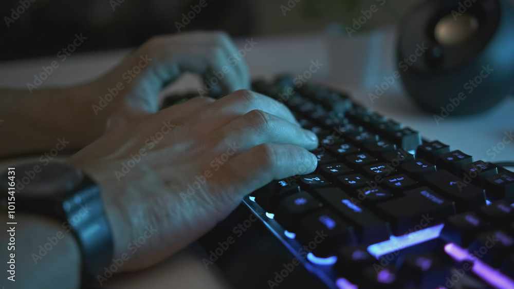 Poster close-up of male hands typing on glowing keyboard. clip. man is typing on professional backlit keybo