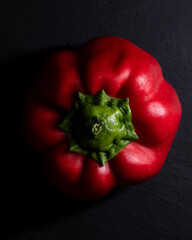 Red bell pepper on a black background