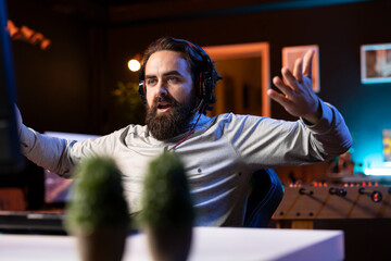 Angry man playing videogames at home, yelling at teammates after being defeated by enemies. Competitive pro gamer raging after failing to win online multiplayer esports match, feeling annoyed