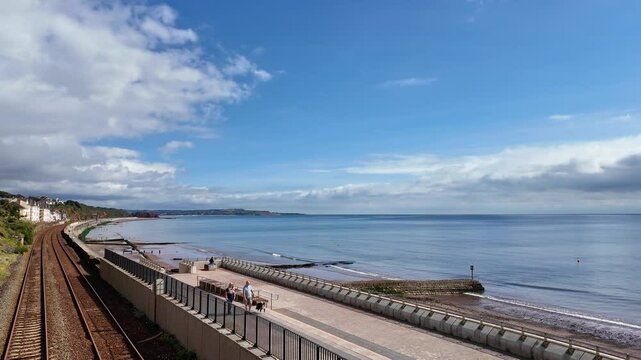 Dawlish south Devon England.  01.10.2024. Video. Dawlish seafront wide walkway and double railway tracks  facing the ocean.