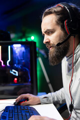 Focused gamer plays intense videogame tournament online during stream with audience, trying to defeat opponent. Player participating in esports competition during livestream, feeling stressed