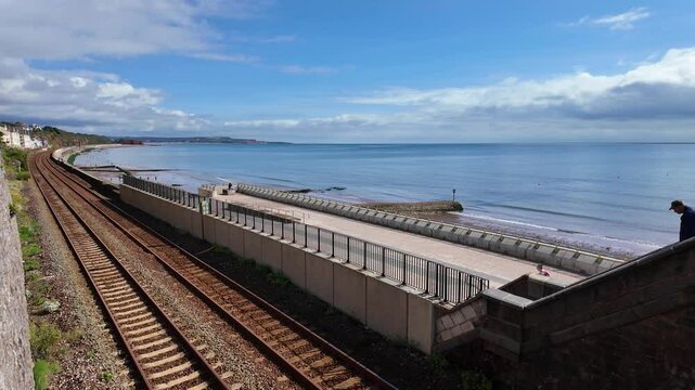 Dawlish south Devon England.  01.10.2024. Video. Dawlish seafront wide walkway and double railway tracks  facing the ocean.