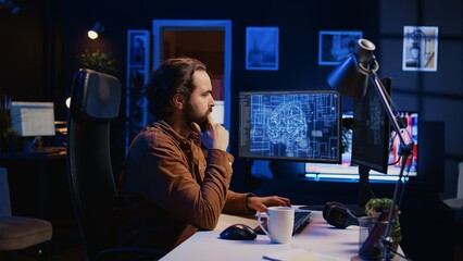 Software developer writes code on multimonitor setup PC to visualize artificial intelligence neural...