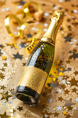 Open a champagne bottle with confetti and sparkles. Birthday anniversary Christmas Valentine day background with copy space. High quality photo