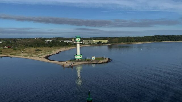 A lighthouse on a wooded coast with a sandy beach in a tranquil water landscape, Friedrichsort, Kiel, Schleswig-Holstein, Germany, Europe