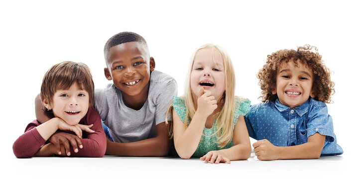 Happy, portrait and kids with diversity for childhood, youth or development on a white studio background. Young, children or group of kindergarten students lying with smile on floor for break or rest