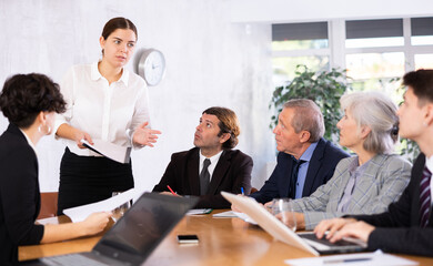 Businesswoman holding meeting for senior managers in the meeting room