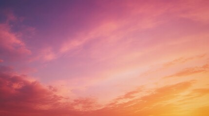 Obraz premium The dawn breaks softly across the horizon, painting the sky in gentle pinks and golds. Cloud formations stretch gracefully, bringing a sense of calm and renewal as a new day begins