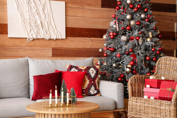 Stylish interior of modern living room with Christmas decor and burning candles
