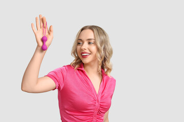 Fototapeta premium Beautiful young woman with anal plug on white background