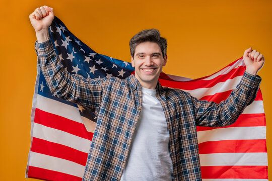 Happy mature man with national USA flag on yellow background. American patriot - Powered by Adobe