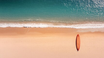 Obraz premium A surfboard is positioned upright in warm sand, creating a long shadow beside gentle waves of a bright turquoise sea, evoking tranquility and adventure on an empty beach