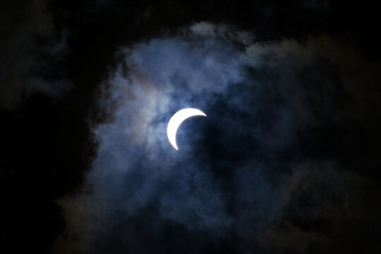 A partial eclipse during a cloudy day.