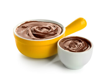 Bowls of tasty melted chocolate on white background