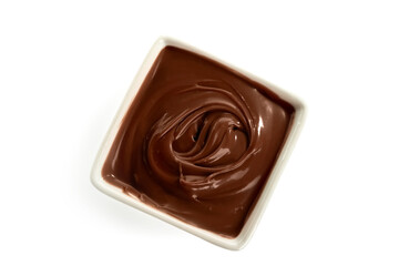 Bowl of tasty melted chocolate on white background