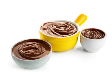 Bowls of sweet melted chocolate on white background