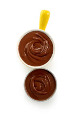 Bowls of sweet melted chocolate on white background