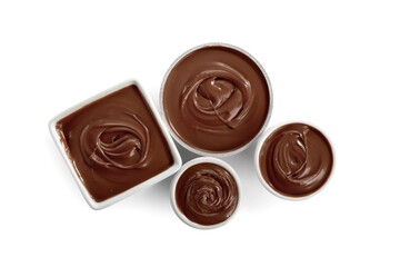 Bowls of tasty melted chocolate on white background