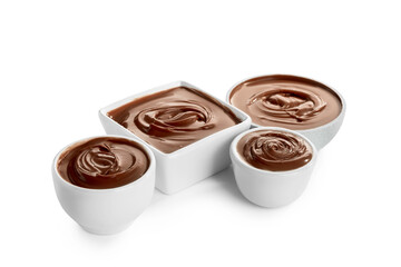 Bowls of sweet melted chocolate on white background