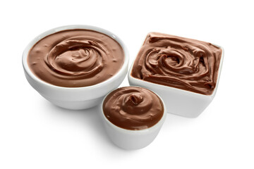 Different bowls of tasty melted chocolate on white background