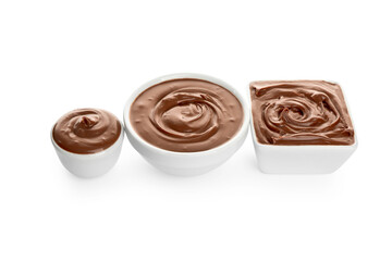 Different bowls of tasty melted chocolate on white background