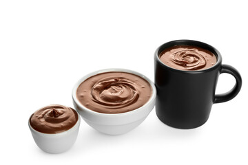 Bowls and cup of tasty melted chocolate on white background