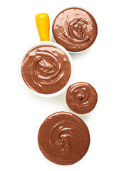 Bowls of tasty melted chocolate on white background
