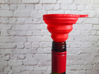Silicone funnel in a glass bottle.