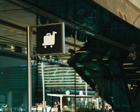 white baggage sign on black background in airport in Krakow