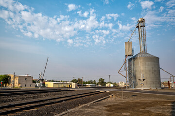 Fototapeta premium A railroad crossing by grain storage bins at Odessa, Washington, USA