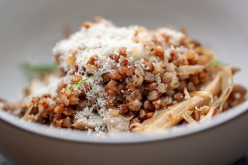 Steaming hot buckwheat is topped with fresh mushrooms and grated parmesan cheese, making a delicious and healthy vegetarian meal