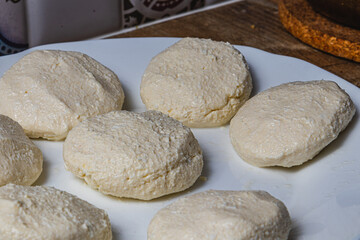 Cottage cheese pancakes on a white plate before frying
