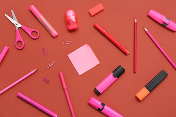 Different stationery on red background. Top view