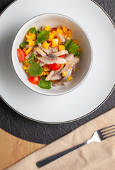 Fresh and flavorful ceviche made with fish, mango, tomato, onion, and cilantro, served with tortilla chips or bread