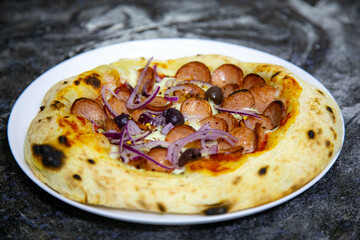 Rustic artisanal pepperoni pizza with red onion