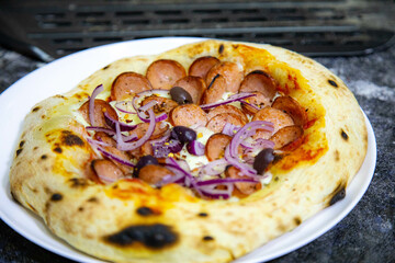 Rustic artisanal pepperoni pizza with red onion